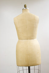 Rear view of Wolf dress form, showing beige linen with subtle patina and waist.
