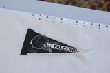 Vintage Atlanta Falcons pennant showing its 9-inch length against a ruler for scale.