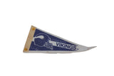 Aged pinholes with yellowed tacks on the spine of a vintage Minnesota Vikings pennant.