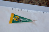 Green Bay Packers pennant tip with green text, slight curl, and brown stain.