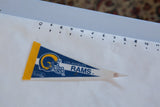 Vintage Rams felt pennant shown against a ruler to demonstrate its 9-inch length.