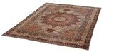 Intricate borders with cranberry and ivory floral motifs on an Antique Kerman rug corner.
