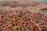 Antique Persian Kerman rug detail featuring intricate ruby red, ivory, and gold daisy motifs.
