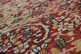 Intricate hand-knotted texture and red, ivory, blue floral motifs on an antique Kerman rug.