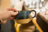 Handmade Ceramic Dark Blue Coffee Mug, two-toned with glazed top and natural speckled clay base.
