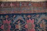 Time-softened raspberry floral medallions and inner vine border on an antique Hamadan runner.