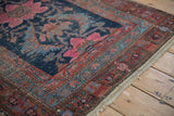 Antique Hamadan runner detail: worn raspberry sickle leaves on navy with vine border.