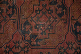 Antique Ersari carpet detail: geometric gul pattern in dusty red, navy, copper with even wear.