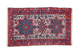 Vintage Persian Karaja rug with a triple center medallion in cherry red, sky blue, and charcoal over an ivory field.