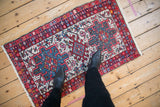 A vintage Karaja rug with a triple medallion design, viewed from overhead to show scale.
