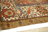 Worn antique Bakshaish rug edge; natural camel border with muted red, blue, seafoam green motifs.