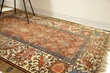 Worn terracotta field and patterned camel, blue borders of a circa 1880's Bakshaish rug.