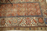 Heavy wear and end reduction on antique Persian Bakshaish rug's patterned border.