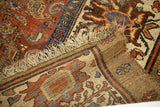 Antique Bakshaish rug detail: camel stripe border, worn geometric patterns, and fringed end.