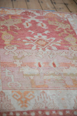 Distressed vintage Turkish Oushak rug pile with heavy abrash, pale raspberry and ivory patterns.