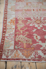 Vintage Distressed Oushak rug texture, showing abrash in pale raspberry red, tangerine, and ivory.