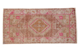 Distressed vintage Oushak runner with a hot pink quatrefoil medallion and earthen tones, 3'x6'1