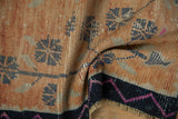 Distressed Oushak rug's pale tangerine field, geometric blossoms, and fuchsia zig-zag border.