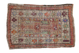 Vintage distressed Oushak rug featuring interconnected medallions, starburst borders, and muted earthy tones.