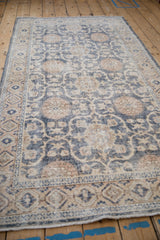 Low angle view along the worn surface of a distressed Turkish Sparta rug.