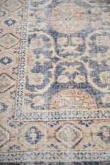 Angled view of the worn, low-pile texture on a vintage distressed Sparta rug.