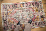 Distressed Oushak rug, faded dusty purple, saffron yellow, and pale blue patterns. Visible foundation.