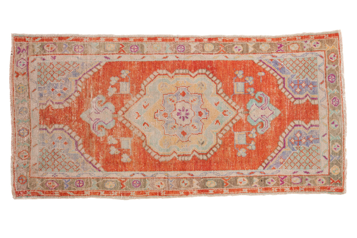 Vintage distressed Oushak runner with a rust medallion field, pale blue, and sea foam green accents.
