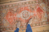 Distressed Oushak rug runner with rust, muted blue field, and visible even wear.