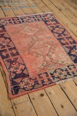 Tomato orange red distressed Oushak rug with visible foundation and navy blue hook and latch border.