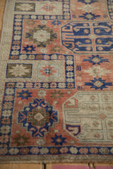 Distressed primitive geometric guls with starburst floral motifs in blush, cobalt, and ivory.