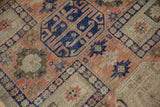Primitive geometric guls in blush, cobalt, and ivory with visible foundation.