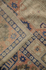 Distressed blush and cobalt blue primitive geometric patterns on the Anatolian rug.