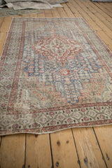 Distressed hand-knotted Sivas rug with faded slate blue, brick red medallion and field.