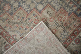 Distressed Sivas rug corner revealing worn pile, hand-knotted foundation, and zigzag pattern.