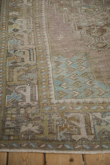 Distressed vintage Oushak runner: detailed arabesque border with mauve, olive, and sky blue hues.