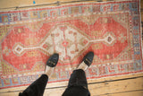 Textured brick red Oushak runner, showcasing diamond medallion and germinating seed motif.