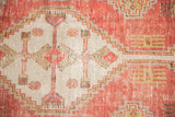 Distressed Oushak rug runner showing ivory field, brick red stepped contours, and germinating seed motifs.