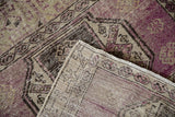 Distressed vintage Oushak rug runner pile with visible foundation, violet, beige, and brown tones.