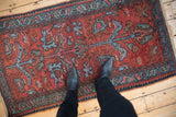 Vintage Lilihan rug runner with cherry red field, blue floral arabesques and subtle wear.