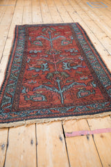 Lilihan rug runner with cherry red field, sky blue floral arabesques, and even wear.
