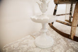 White Cambridge table lamp with chippy paint, fluted base, and ornate leaf details.