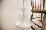 Vintage white Cambridge lamp with ornate floral details and scalloped base.
