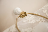 Cambridge lamp's ornate white floral finial with chippy paint and brass details.
