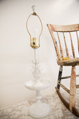 Chippy white Cambridge table lamp with floral accents, highlighting its vintage character.