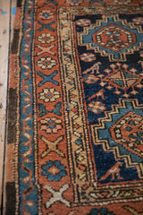 Intact side cord selvage and wide floral border of an antique Persian Heriz rug.