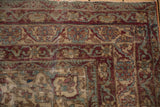Hand-knotted Antique Kermanshah rug corner, showing intricate cochineal red and powder blue floral arabesque borders.