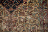 Antique Kermanshah rug's field: cochineal red blossoms, coffee brown vines, and foundation showing.