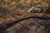 Textural close-up of worn antique Kermanshah rug, revealing foundation and faded floral motifs.