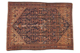 Antique Malayer rug, navy blue allover Herati pattern, stepped terracotta spandrels, visible wear.