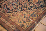 Worn corner of antique Malayer rug, terracotta border and navy saffron Herati field.